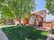 Beautiful home exterior with well-manicured lawn and mature trees at 2485 Greensborough Cir, Highlands Ranch, CO 80129
