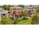 Back exterior of home showcasing a multi-level deck with stone pillars and a fenced yard at 2485 Greensborough Cir, Highlands Ranch, CO 80129