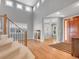 Grand foyer with high ceilings, hardwood floors, staircase, and lots of natural light at 2485 Greensborough Cir, Highlands Ranch, CO 80129