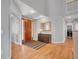 Elegant foyer with hardwood floors, a wooden door, and a glimpse of the laundry area at 2485 Greensborough Cir, Highlands Ranch, CO 80129
