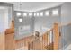 Second floor landing with staircase, tall windows, and light fixture, overlooking the foyer at 2485 Greensborough Cir, Highlands Ranch, CO 80129