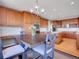 Kitchen with a large island adjoins dining area with chandelier at 2485 Greensborough Cir, Highlands Ranch, CO 80129