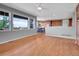 Open-concept living room with hardwood floors, natural light, and a view of the kitchen at 2485 Greensborough Cir, Highlands Ranch, CO 80129
