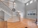Bright living room with soaring ceilings, hardwood floors, and staircase at 2485 Greensborough Cir, Highlands Ranch, CO 80129
