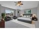 Comfortable bedroom with king bed, chair, windows and tasteful decorations at 2485 Greensborough Cir, Highlands Ranch, CO 80129