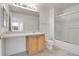 Clean bathroom, shower/tub combo, vanity with wood cabinets at 7440 S Blackhawk St # 101, Englewood, CO 80112