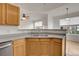 Gray countertops and wood cabinets in this updated kitchen at 7440 S Blackhawk St # 101, Englewood, CO 80112