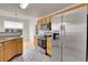 Stainless steel appliances and wood cabinets highlight this kitchen at 7440 S Blackhawk St # 101, Englewood, CO 80112