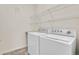 Laundry room with washer, dryer, and shelving for storage at 7440 S Blackhawk St # 101, Englewood, CO 80112