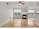 Spacious living room with hardwood floors and a cozy fireplace at 7440 S Blackhawk St # 101, Englewood, CO 80112