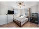 Comfortable bedroom featuring natural light, ceiling fan, and wood-look flooring at 9450 Lillian Ln, Thornton, CO 80229