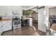 Functional kitchen featuring modern appliances, white cabinetry, and an open layout that connects to other living spaces at 9450 Lillian Ln, Thornton, CO 80229