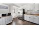 Well-lit kitchen featuring stainless steel appliances and wood-look flooring at 9450 Lillian Ln, Thornton, CO 80229