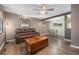 Open concept living and dining area with hardwood floors, ceiling fan, and plentiful natural light at 9450 Lillian Ln, Thornton, CO 80229