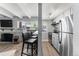 Modern kitchen with stainless steel appliances and breakfast bar at 200 N Pearl St # 104, Denver, CO 80203