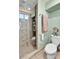 Compact bathroom featuring tiled shower with glass door, and tiled floor at 2580 Valley View Dr, Denver, CO 80221