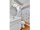 Well-lit bathroom featuring a decorative shower curtain and modern vanity at 2580 Valley View Dr, Denver, CO 80221