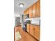 Updated kitchen featuring stainless steel appliances, wooden cabinets, and modern countertops at 2580 Valley View Dr, Denver, CO 80221