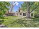 Lush backyard with a well-maintained lawn, mature trees, and storage shed, offering a private outdoor space at 8144 W 81St Dr, Arvada, CO 80005