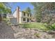 Scenic backyard featuring a well-kept lawn, mature trees, and a charming storage shed at 8144 W 81St Dr, Arvada, CO 80005