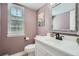 Charming bathroom features a sleek white vanity, modern fixtures, and plenty of natural light at 8144 W 81St Dr, Arvada, CO 80005