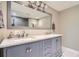 Modern bathroom featuring a dual sink vanity with a marble countertop and chrome fixtures at 8144 W 81St Dr, Arvada, CO 80005