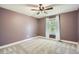 Cozy bedroom with a ceiling fan, large window with view, and soft neutral carpet creating a relaxing space at 8144 W 81St Dr, Arvada, CO 80005