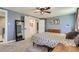 This bedroom offers carpet flooring, an ensuite bathroom, ceiling fan, and natural light at 8144 W 81St Dr, Arvada, CO 80005