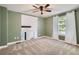 Spacious bedroom with a ceiling fan, large windows, and neutral carpet providing an open, airy feel at 8144 W 81St Dr, Arvada, CO 80005