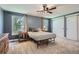 Cozy bedroom with carpet flooring, ceiling fan, windows for natural light, and closet with sliding doors at 8144 W 81St Dr, Arvada, CO 80005