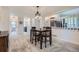 Cozy dining area features a modern light fixture, and is adjacent to an upper level living area at 8144 W 81St Dr, Arvada, CO 80005