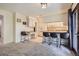 Eat-in kitchen featuring white cabinets, modern appliances, and a breakfast bar with seating at 8144 W 81St Dr, Arvada, CO 80005