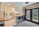 Eat-in kitchen featuring white cabinets, modern appliances, and a breakfast bar with seating at 8144 W 81St Dr, Arvada, CO 80005