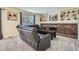 Cozy living room with a brick fireplace, built-in shelves, and comfortable seating at 8144 W 81St Dr, Arvada, CO 80005