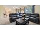Comfortable living room with a large sectional sofa, coffee table, and views into the kitchen at 8144 W 81St Dr, Arvada, CO 80005