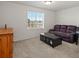 Cozy bedroom with plush carpet, large window, and comfortable furnishings at 21901 E 42Nd Pl, Aurora, CO 80019