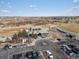 Aerial view of the clubhouse with a parking lot and golf course nearby at 21901 E 42Nd Pl, Aurora, CO 80019