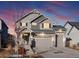 Beautiful two-story home with stone accents, three car garage, gray siding and a landscaped front yard at 21901 E 42Nd Pl, Aurora, CO 80019