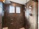 Modern shower with tiled walls, glass door, and dual shower heads at 21901 E 42Nd Pl, Aurora, CO 80019