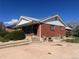 Charming red brick home with well-maintained landscaping and a cozy front porch at 10885 Mildred Dr, Northglenn, CO 80233