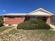 Charming brick home featuring a well-maintained front yard with lush green shrubbery at 10885 Mildred Dr, Northglenn, CO 80233