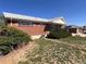 Charming brick home featuring a well-maintained front yard with lush green shrubbery at 10885 Mildred Dr, Northglenn, CO 80233