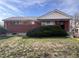 Charming brick home featuring a well-maintained front yard with lush green shrubbery at 10885 Mildred Dr, Northglenn, CO 80233