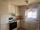 Traditional kitchen with white cabinets, wood-look countertops, and a double basin stainless steel sink at 10885 Mildred Dr, Northglenn, CO 80233