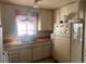 Traditional kitchen with white cabinets, wood-look countertops, and a white refrigerator at 10885 Mildred Dr, Northglenn, CO 80233
