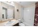 Bright bathroom featuring a vanity with a neutral countertop and a tub with white tiled walls at 12704 Leyden St # D, Thornton, CO 80602