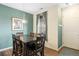 Cozy dining area with a wooden table, seating for six, and natural light from a window at 12704 Leyden St # D, Thornton, CO 80602