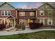Inviting townhome featuring warm-toned siding, stone accents, manicured landscaping, and a welcoming walkway at 12704 Leyden St # D, Thornton, CO 80602