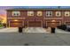 Attached garage with driveways and manicured lawns in a quiet neighborhood with dark asphalt streets at 12704 Leyden St # D, Thornton, CO 80602
