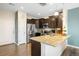Bright kitchen showcasing stainless steel appliances, granite counters, and dark wood cabinetry at 12704 Leyden St # D, Thornton, CO 80602